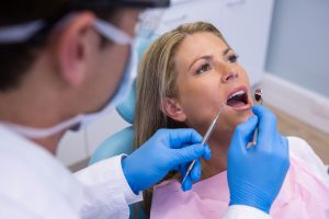 dentist examining woman mouth